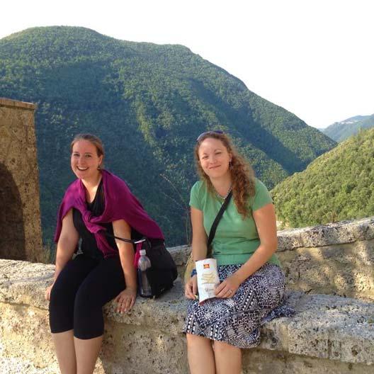 Benedictine students sitting on an old structure overlooking a beautiful landscape in Florence, Italy